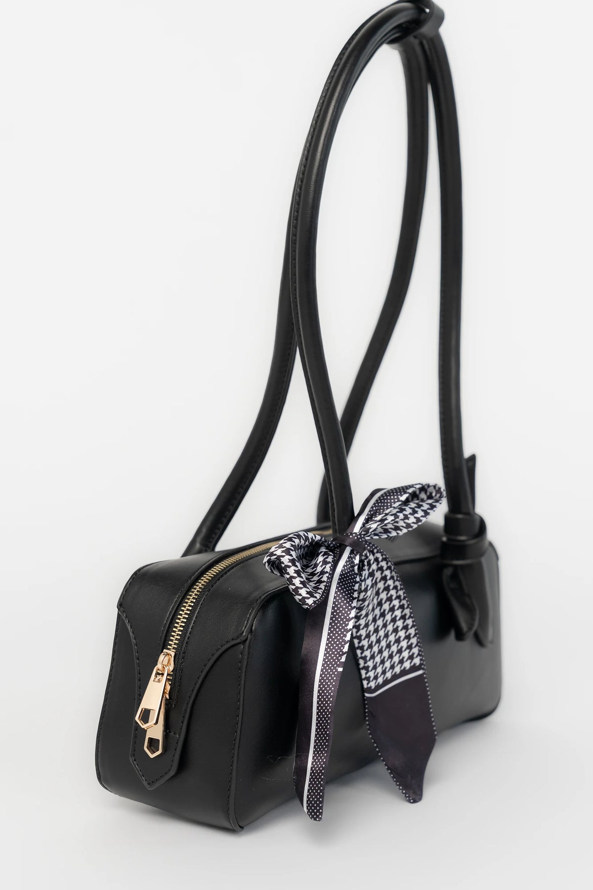 Harmony Mini Shoulder Bag in Black with gold zipper hardware, removable bow, shoulder strap, and interior pockets.