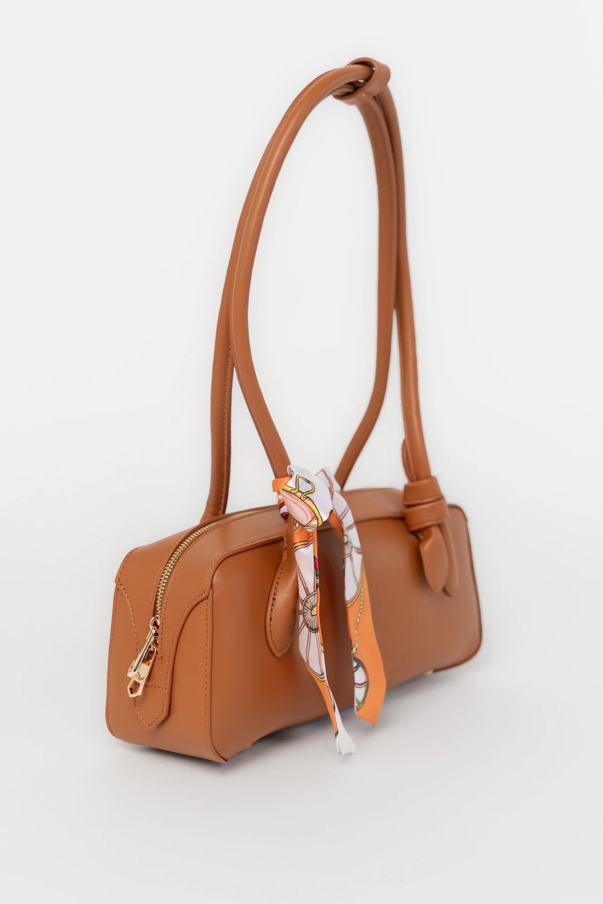 Harmony Mini Shoulder Bag in Camel with gold zipper hardware, removable bow, shoulder strap, and interior pockets.