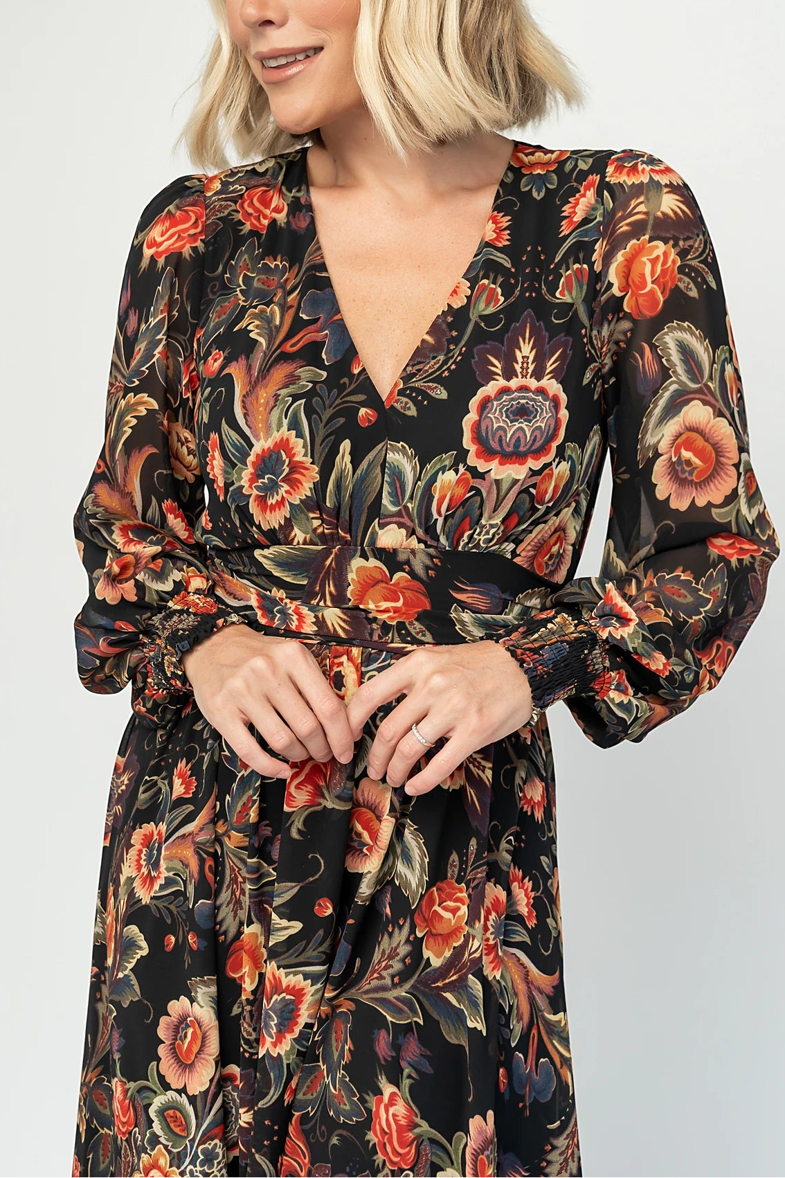 Hera Maxi Dress in Black Multi Print with deep V-neckline, long sleeves, gathered waist, and smocked back.