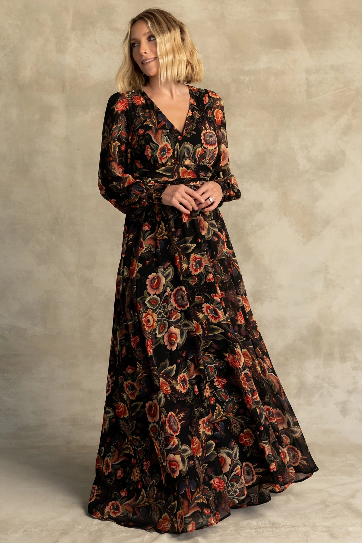 Hera Maxi Dress in Black Multi Print with deep V-neckline, long sleeves, gathered waist, and smocked back.