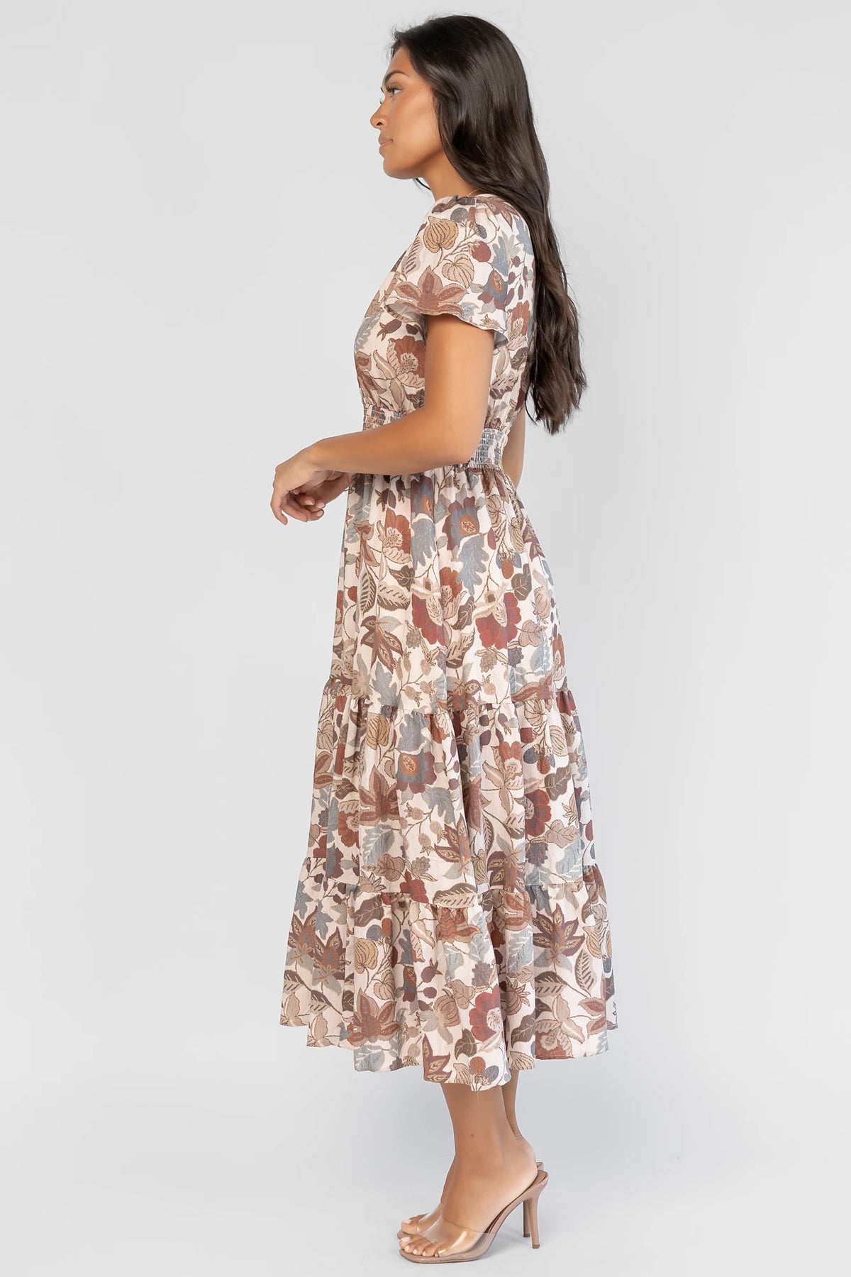 Holland Dress in Taupe Multi with a smocked waist, V-neckline, flutter sleeves, and a floral print.