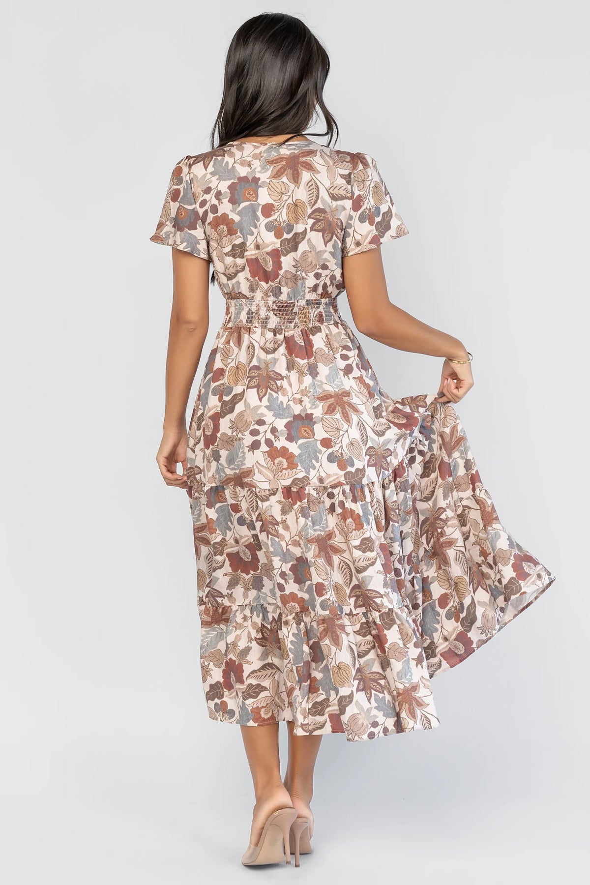 Holland Dress in Taupe Multi with a smocked waist, V-neckline, flutter sleeves, and a floral print.