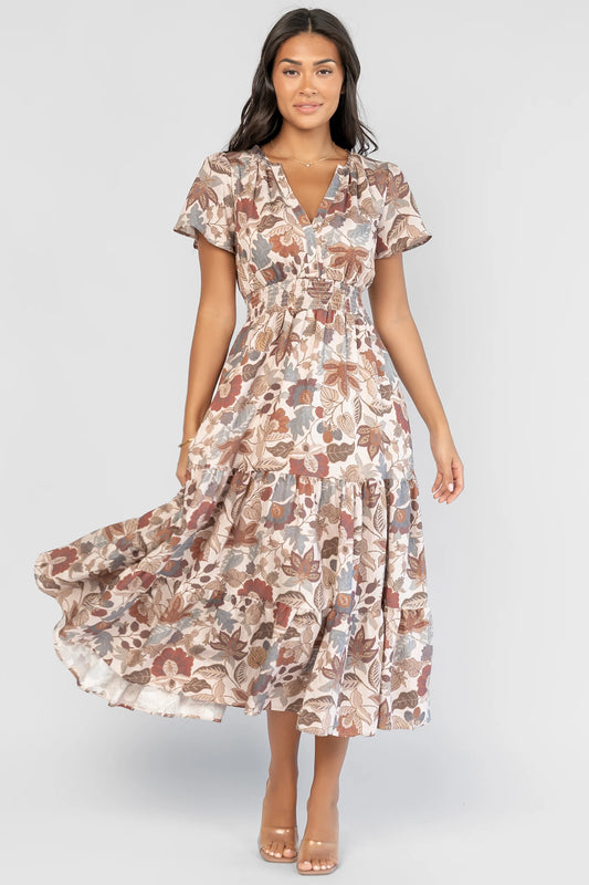 Holland Dress in Taupe Multi with a smocked waist, V-neckline, flutter sleeves, and a floral print.