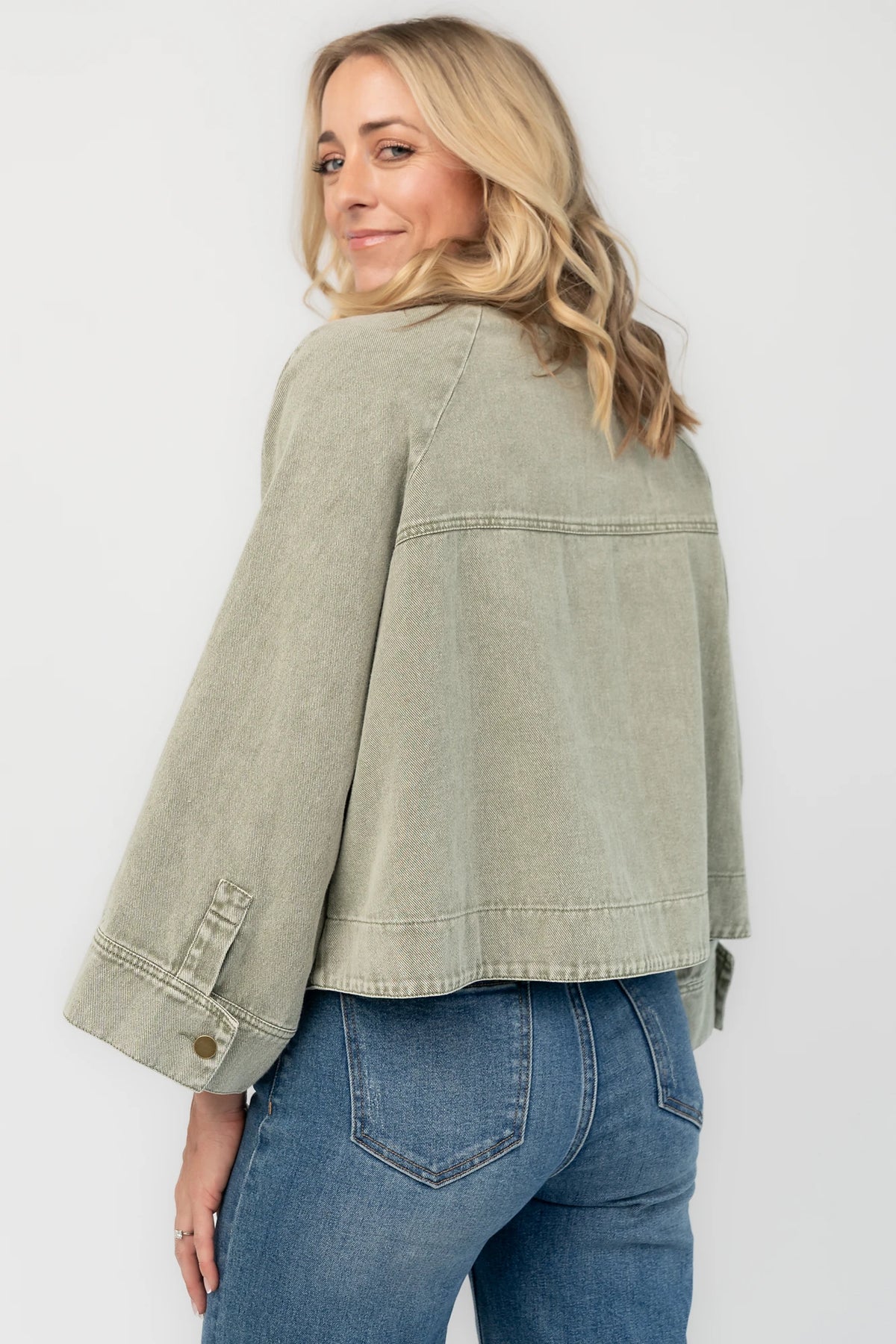 Dusty Olive Cropped Cotton Jacket with collared neckline, button front, raglan sleeves, adjustable cuffs, and side pockets.