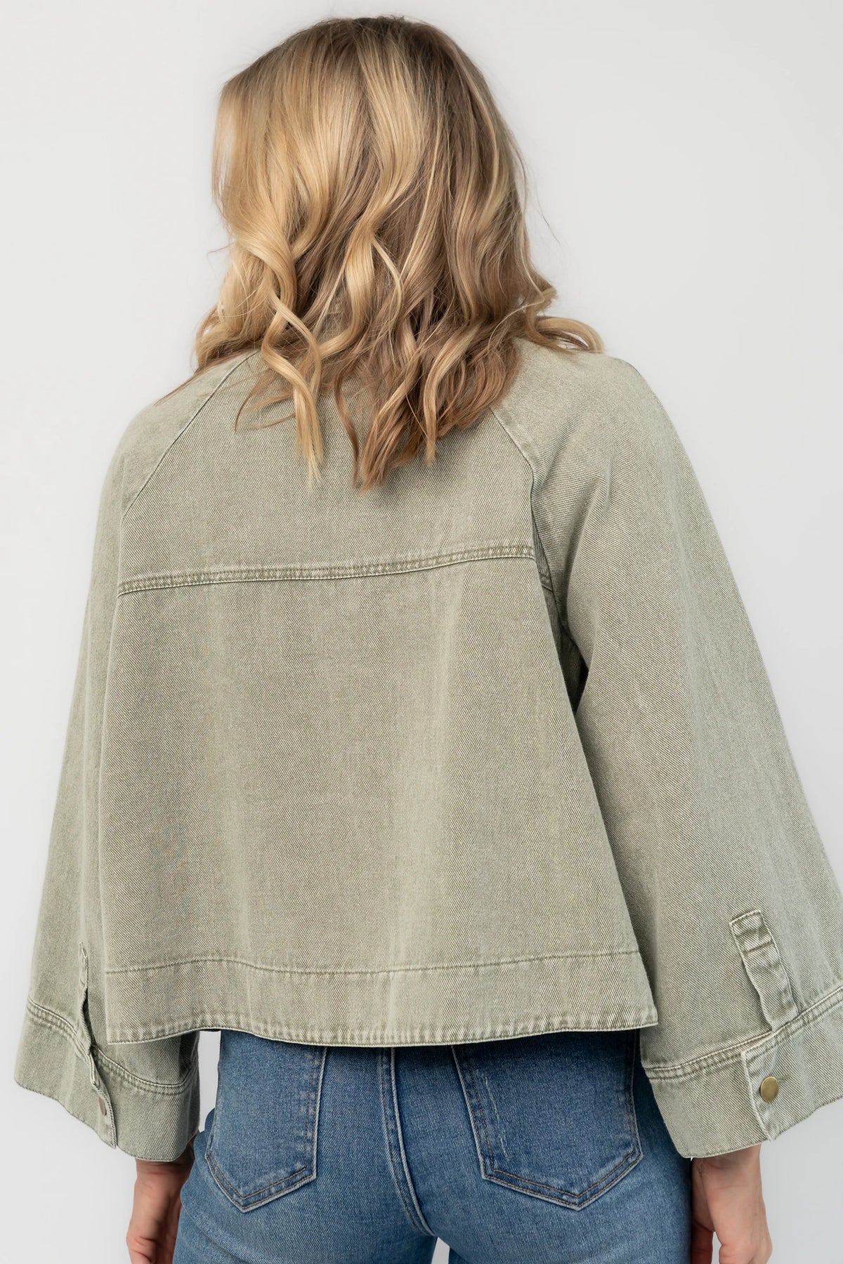 Dusty Olive Cropped Cotton Jacket with collared neckline, button front, raglan sleeves, adjustable cuffs, and side pockets.