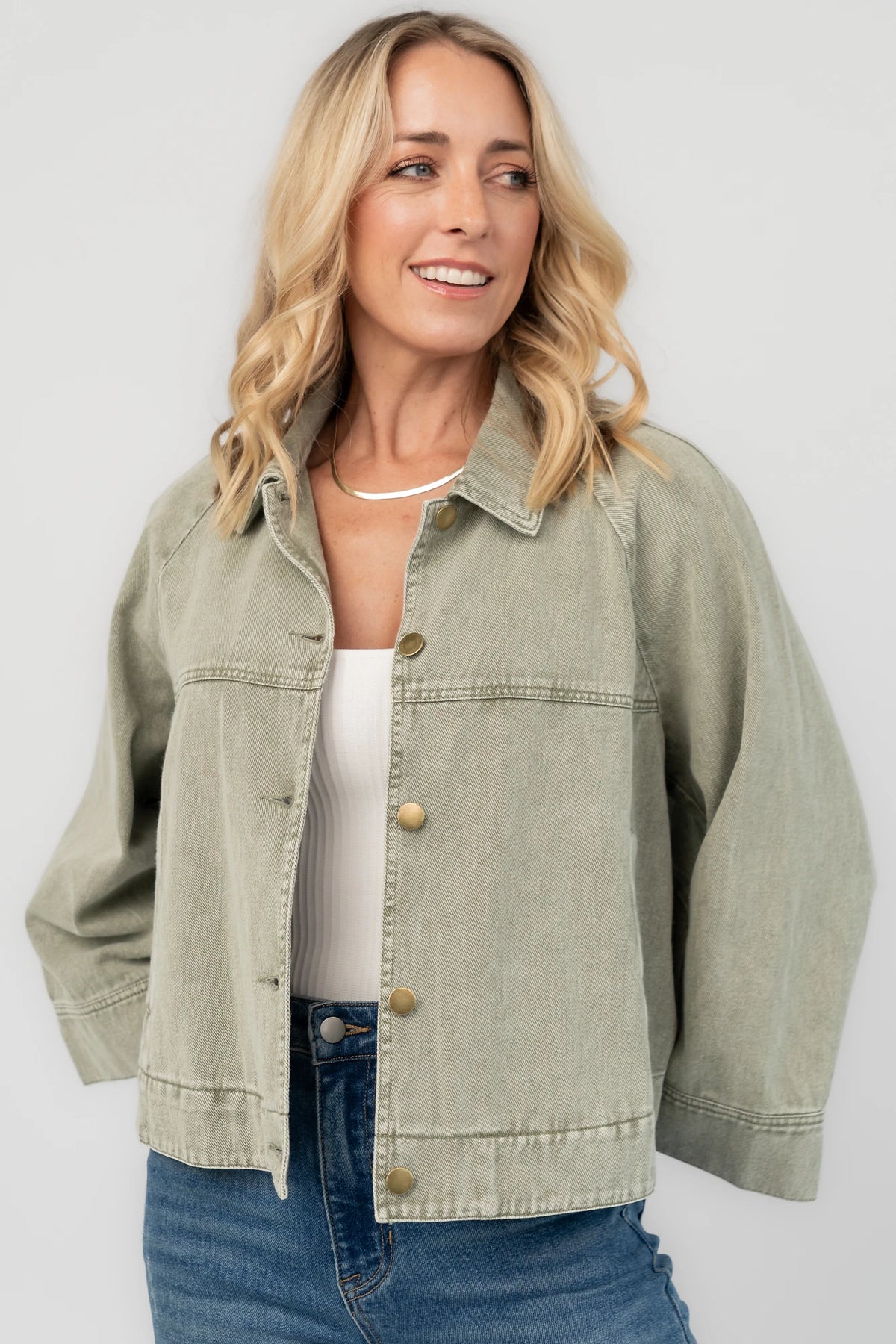 Dusty Olive Cropped Cotton Jacket with collared neckline, button front, raglan sleeves, adjustable cuffs, and side pockets.