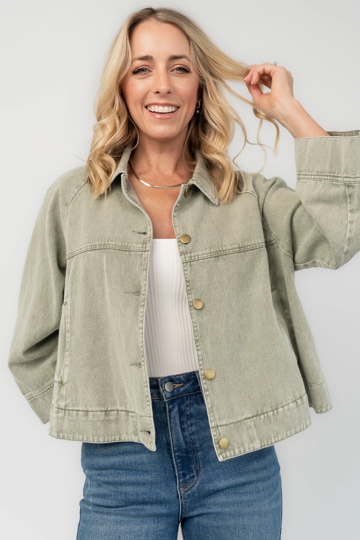 Dusty Olive Cropped Cotton Jacket with collared neckline, button front, raglan sleeves, adjustable cuffs, and side pockets.