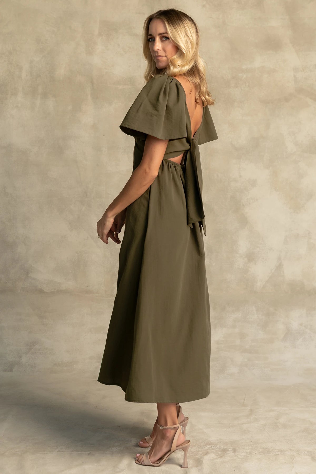 Indie Back Tie Dress in Olive with sweetheart neckline, butterfly sleeves, open tie-back, and side pockets.