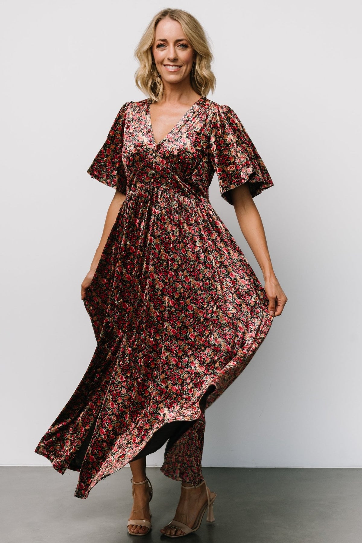 Styled outfit image of the Irina Velvet Maxi Dress in black multi floral paired with heels to show length and overall drape.