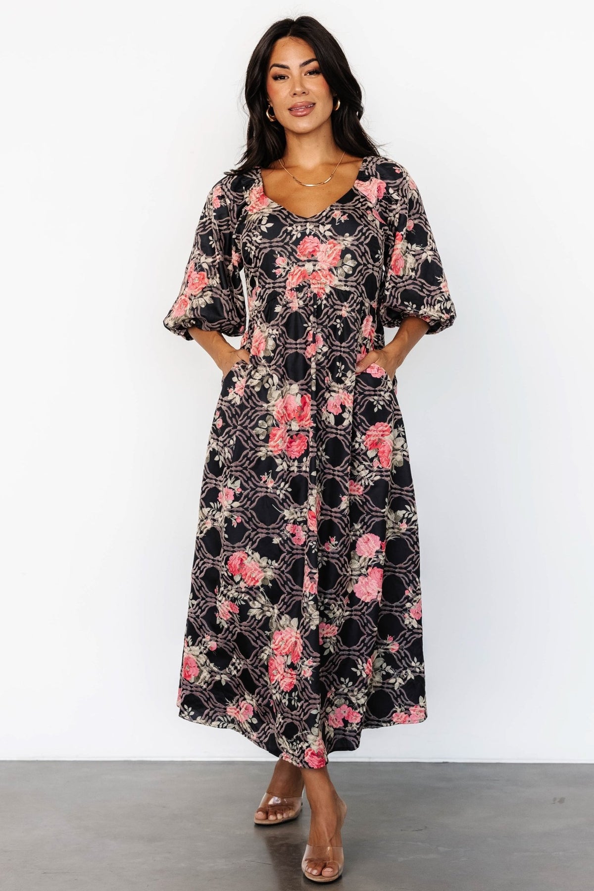 Front view of Ivanna Embroidered Satin Midi Dress in black with pink floral embroidery, full-length shot showing V-neck and pockets.