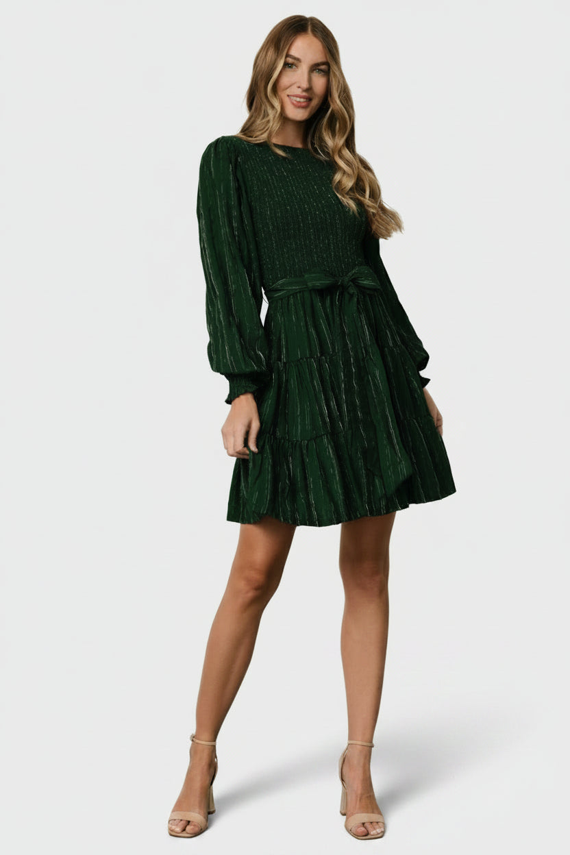 Front view of Ivey smocked short dress in dark green with silver pinstripes; shows smocked bodice, high round neckline, and removable sash.