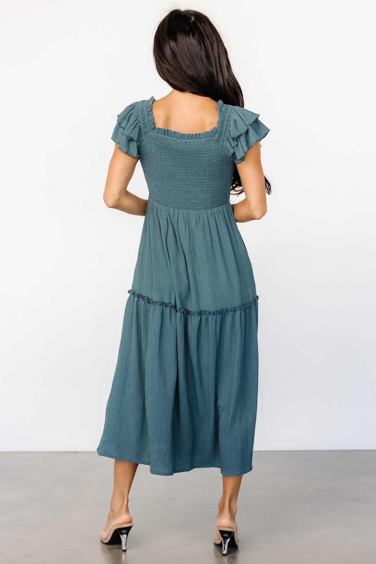 Back view of the Jacie Smocked Midi Dress in vintage teal on model, showing smocked back bodice and gentle midi skirt drape for a flattering silhouette.