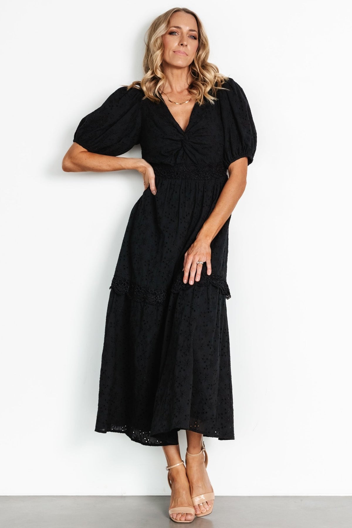 Full-length view of the tiered skirt and movement of the fabric, highlighting lace-insert detail at the skirt tier edge.