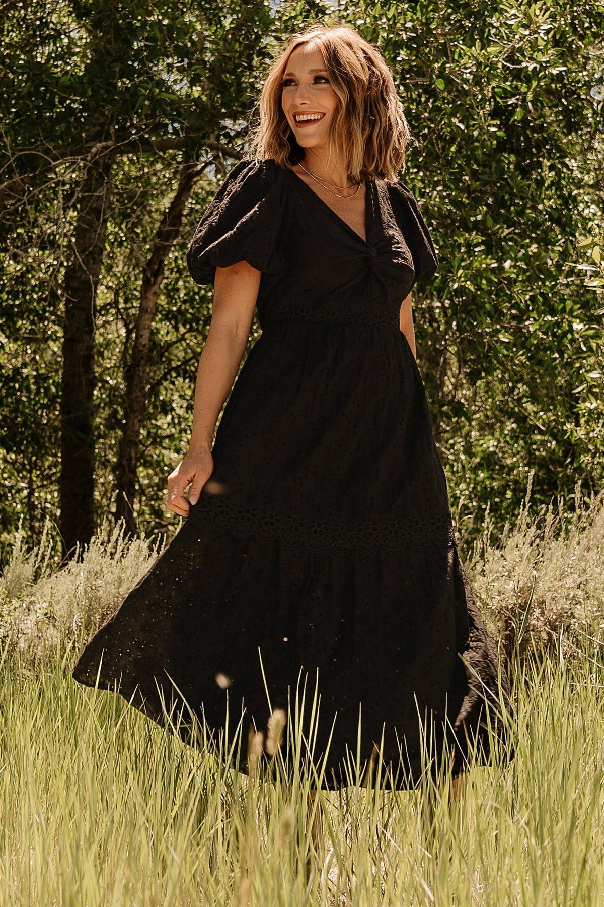 Image showing sleeve detail: mid-length puff sleeve with elastic cuff and eyelet embroidery near the shoulder area.