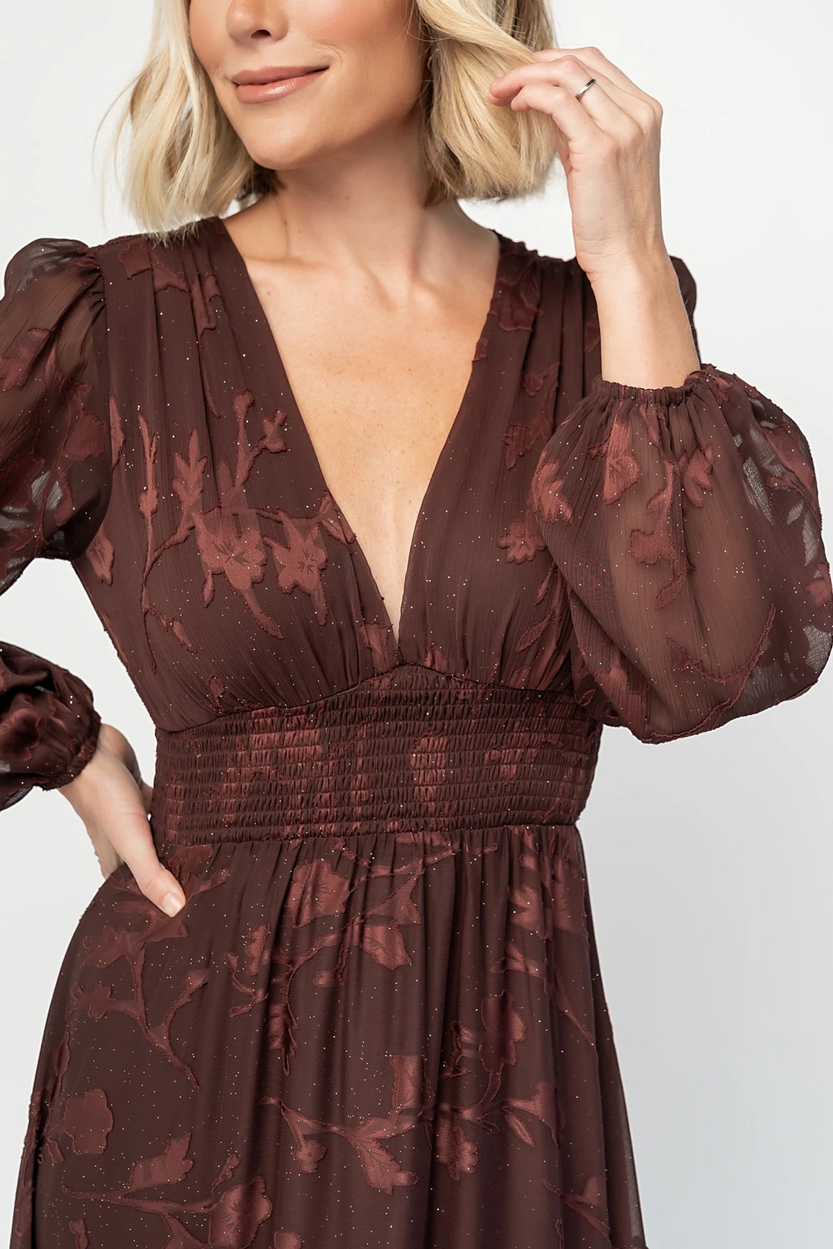 Jennifer Maxi Dress in Dark Mahogany with plunging V-neck, sheer long sleeves, gold sparkle, and textured florals.