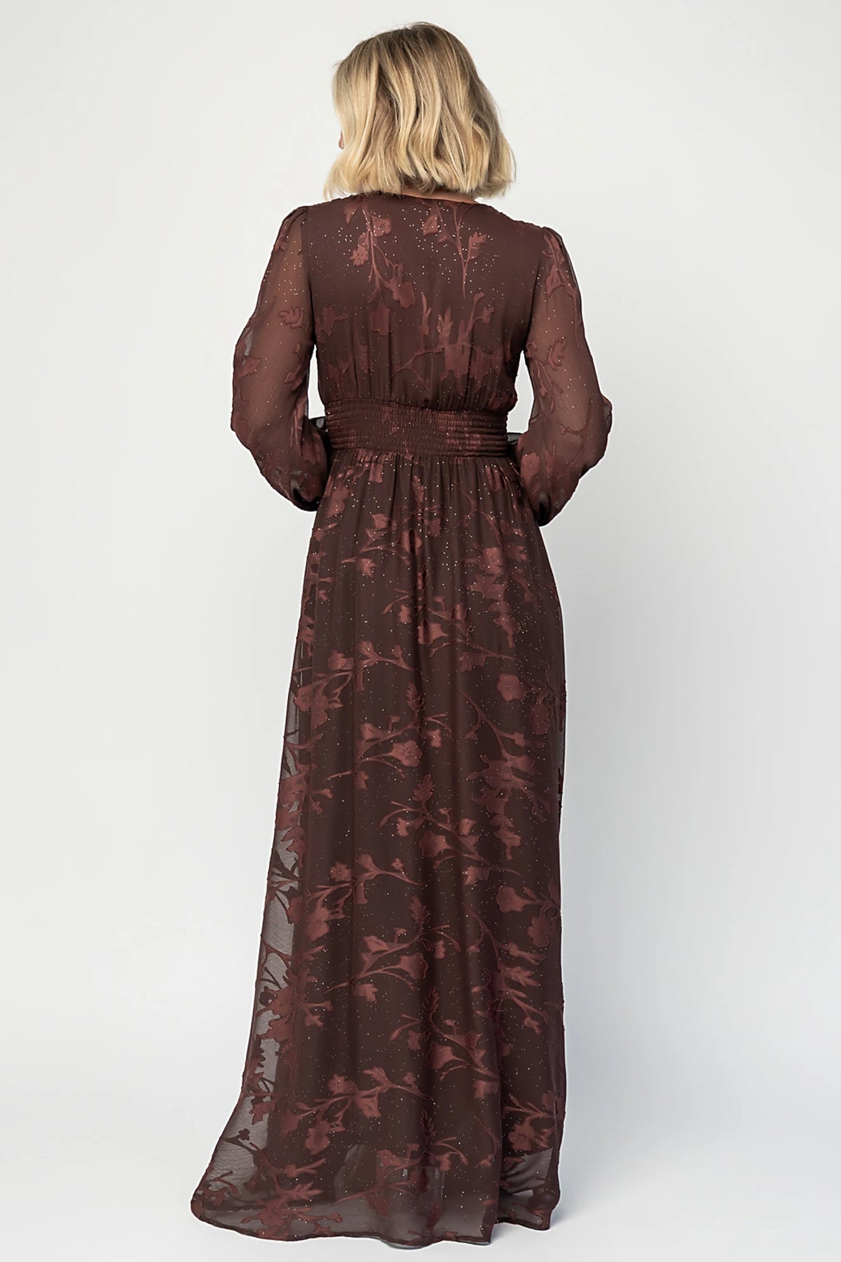 Jennifer Maxi Dress in Dark Mahogany with plunging V-neck, sheer long sleeves, gold sparkle, and textured florals.