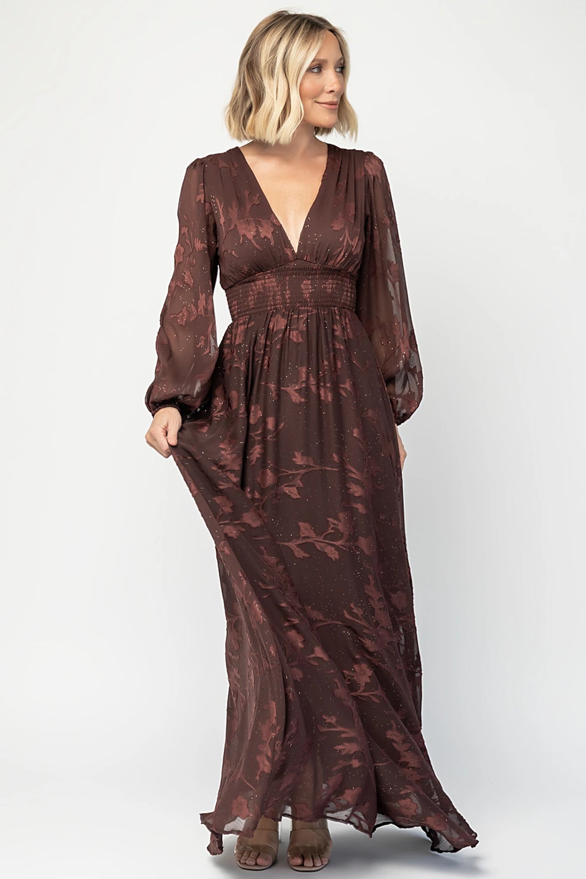 Jennifer Maxi Dress in Dark Mahogany with plunging V-neck, sheer long sleeves, gold sparkle, and textured florals.
