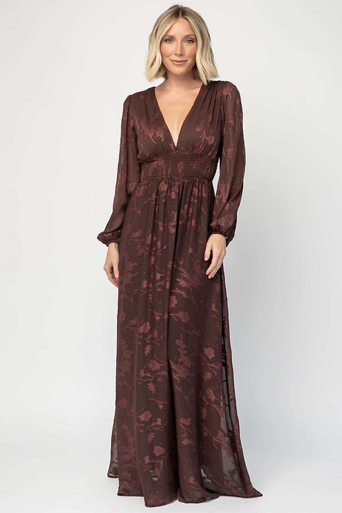 Jennifer Maxi Dress in Dark Mahogany with plunging V-neck, sheer long sleeves, gold sparkle, and textured florals.