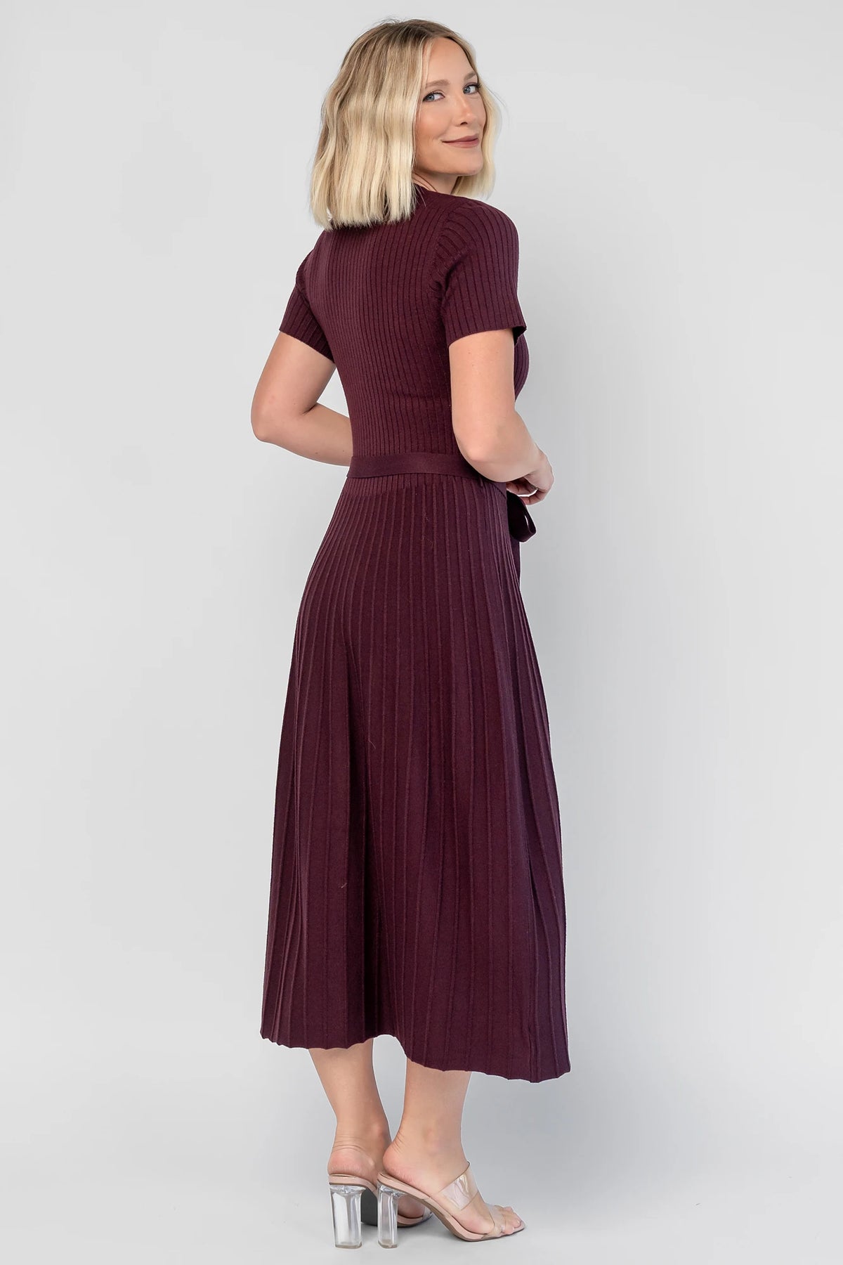 Jessamine Midi Dress in Dark Plum with a ribbed sweater knit, crew neckline, waist belt, and pleated midi skirt.