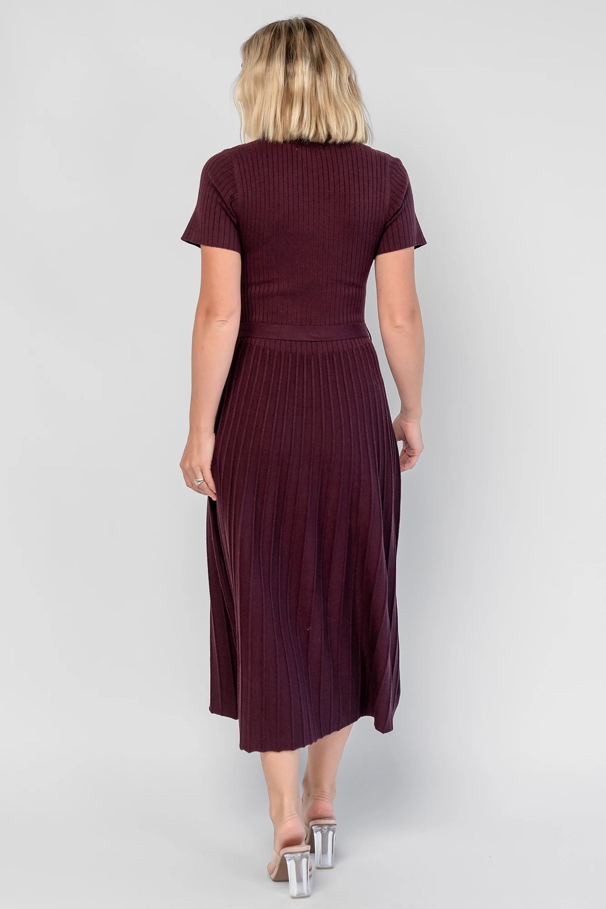Jessamine Midi Dress in Dark Plum with a ribbed sweater knit, crew neckline, waist belt, and pleated midi skirt.