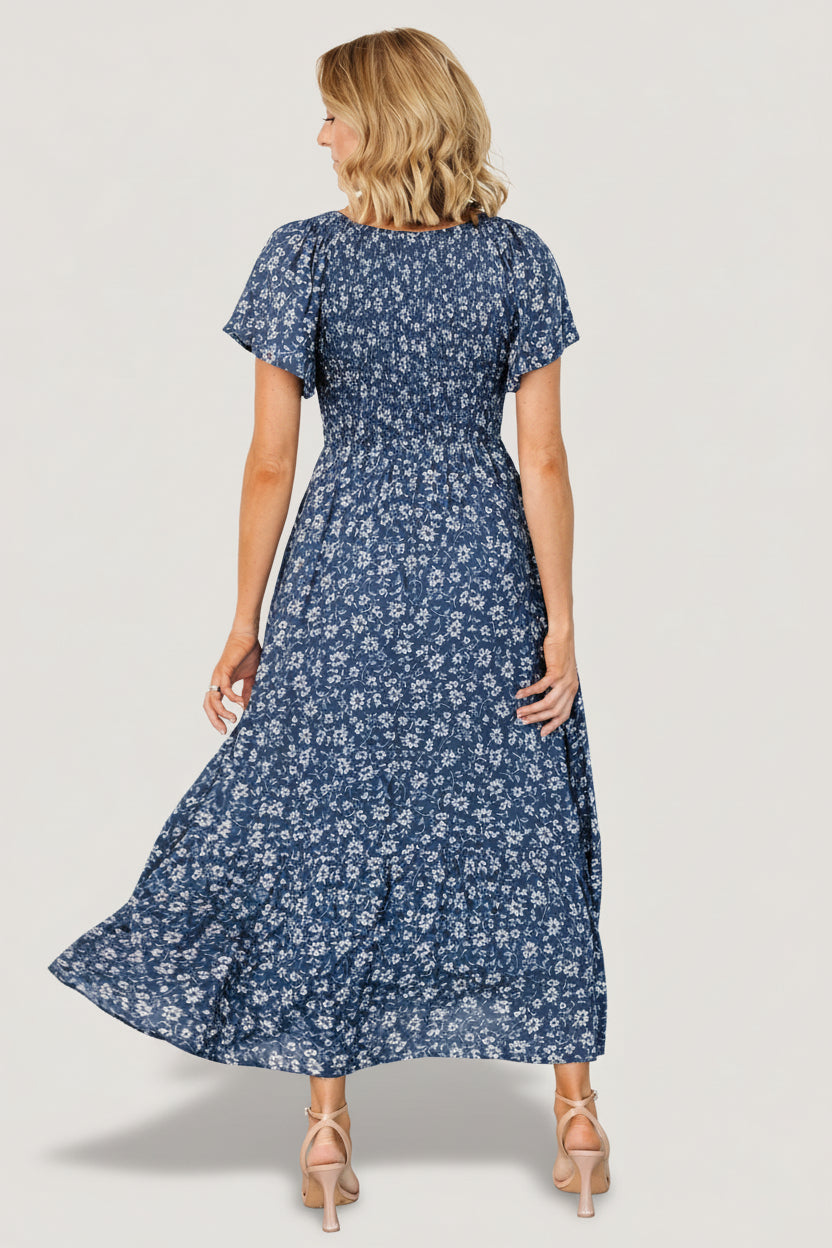 Back and side view of Joanie Smocked Midi Dress highlighting empire waist, flutter sleeve, and single-tier skirt.