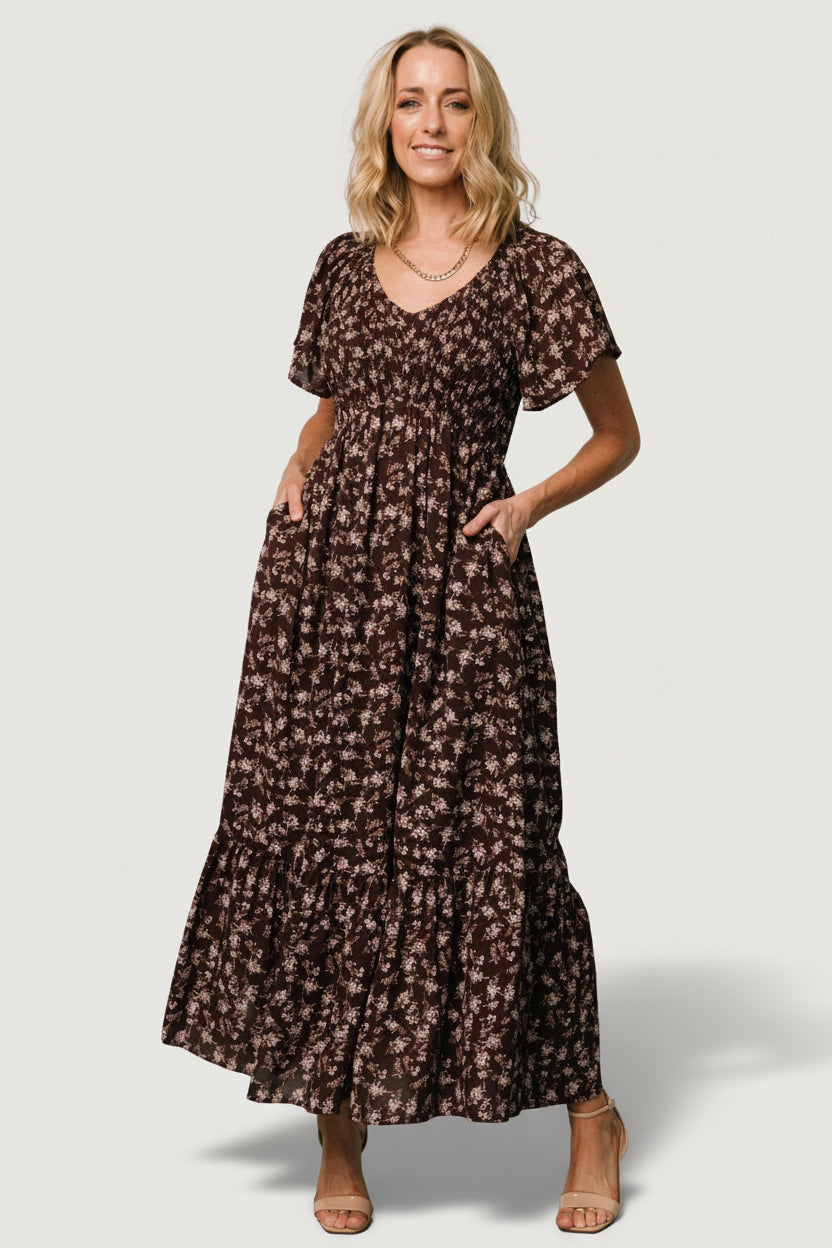 Side view of Joanie Smocked Midi Dress in clove floral demonstrating the hidden side pocket and drape of the skirt while walking.