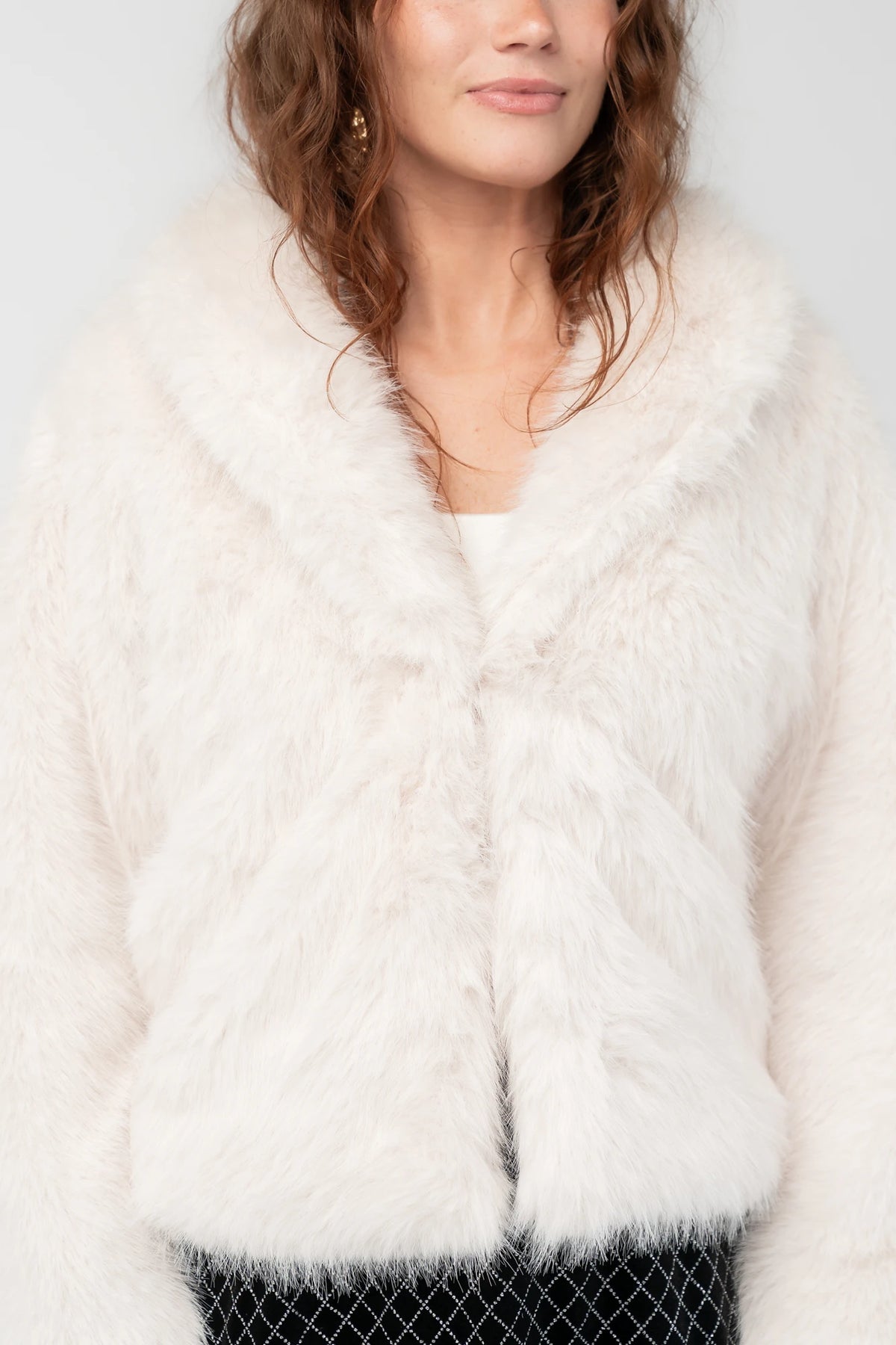 Jubilee Faux Fur Coat in Ivory with plush faux fur, open front, long sleeves, and relaxed silhouette.