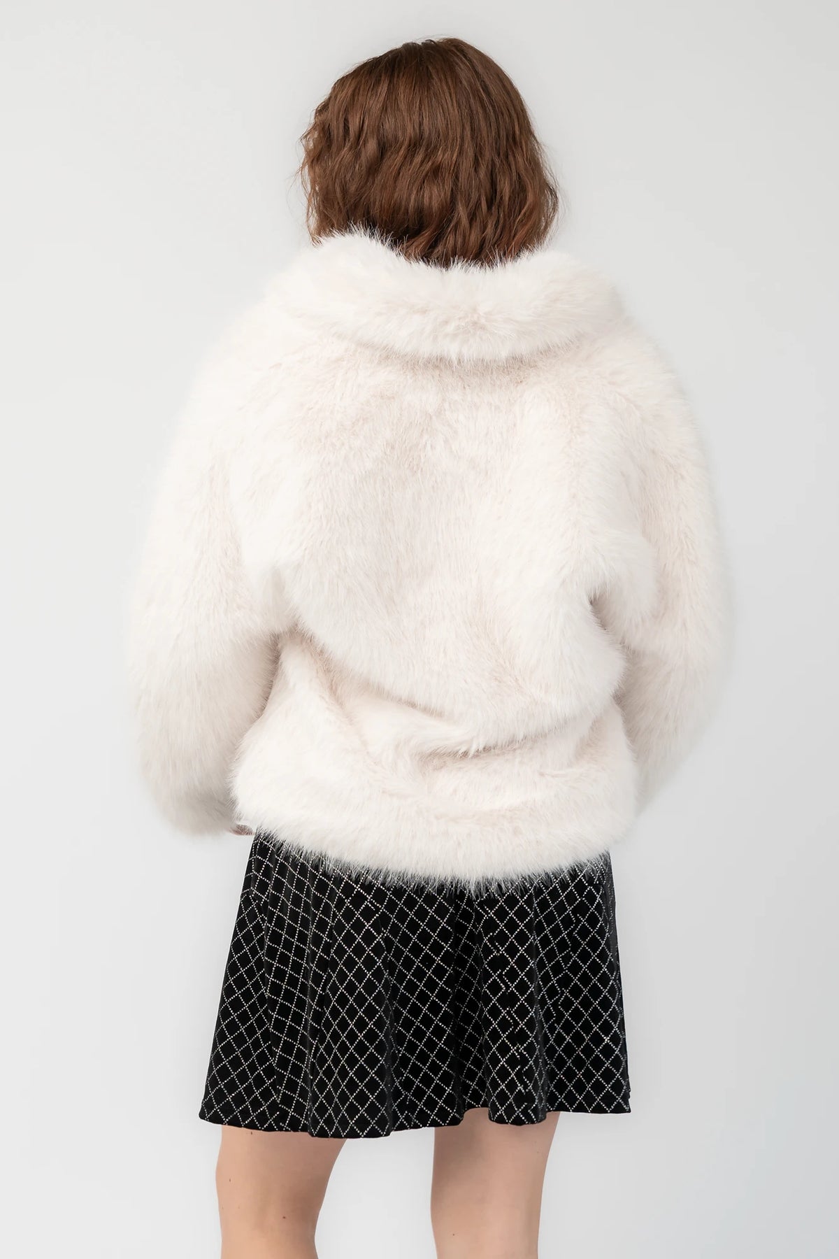 Jubilee Faux Fur Coat in Ivory with plush faux fur, open front, long sleeves, and relaxed silhouette.