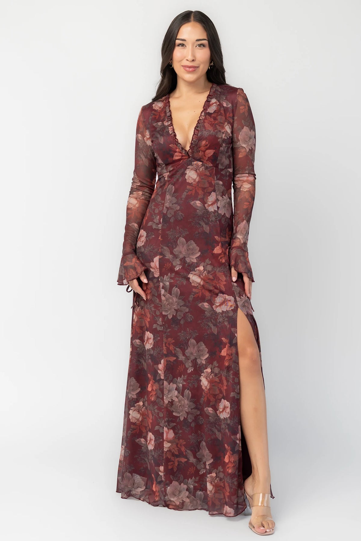 Julietta Maxi Dress in Mahogany Rose Floral with plunging V-neck, sheer long sleeves, ruffle trim, and leg slit.