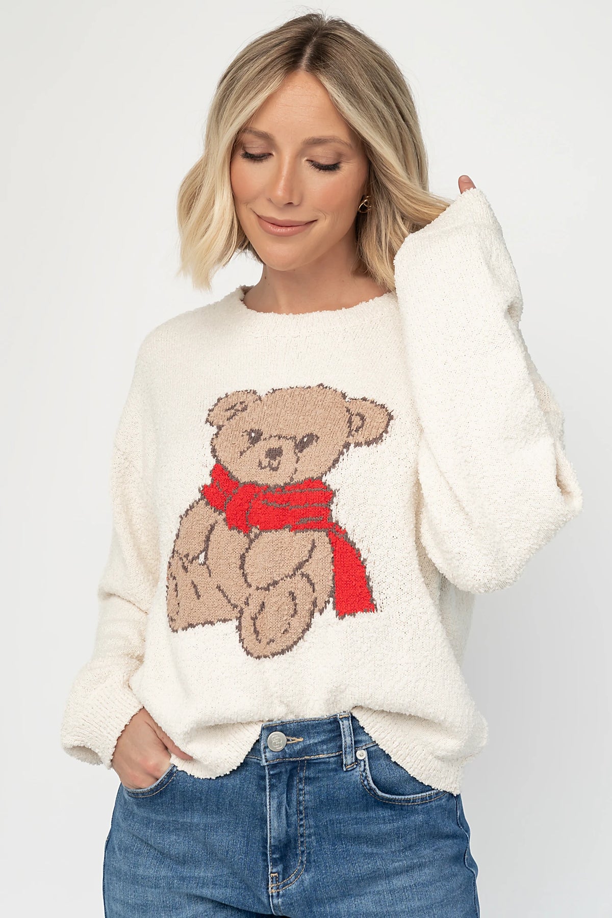 Junie Cozy Bear Sweater in Ivory with teddy bear graphic, red scarf, crew neckline, and ribbed trim.