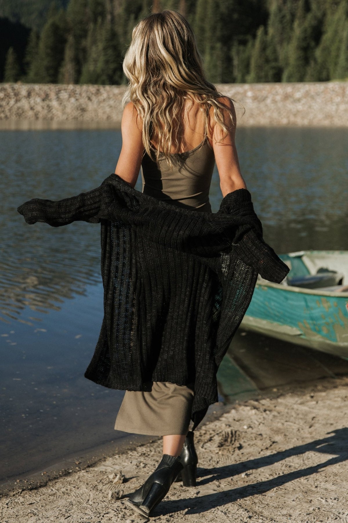 Detail shot of the side slit and seam of the Kade ribbed tank dress in dusty olive, emphasizing the cut and finish above the knee.