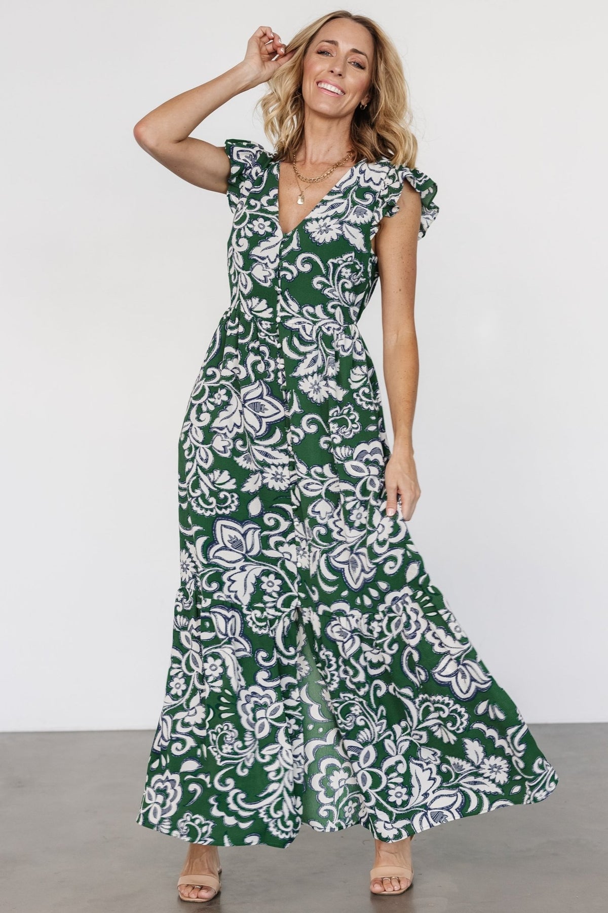 Side view of Kaia Button Maxi Dress showing cap-style flutter sleeve, hidden side pocket placement, and soft drape of georgette fabric.