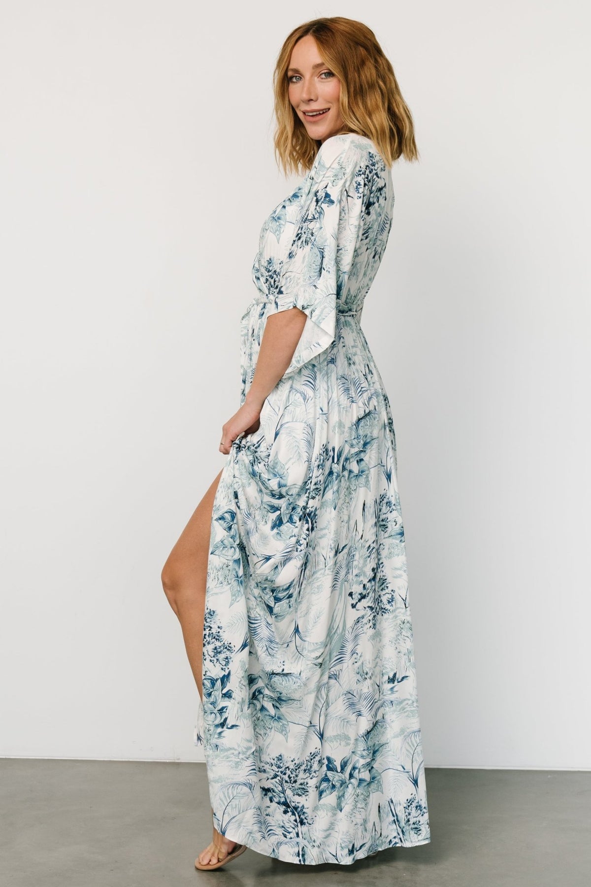 Side view of Kalea maxi dress showing left-side leg slit and flowing skirt for ease of movement and a flirty finish.