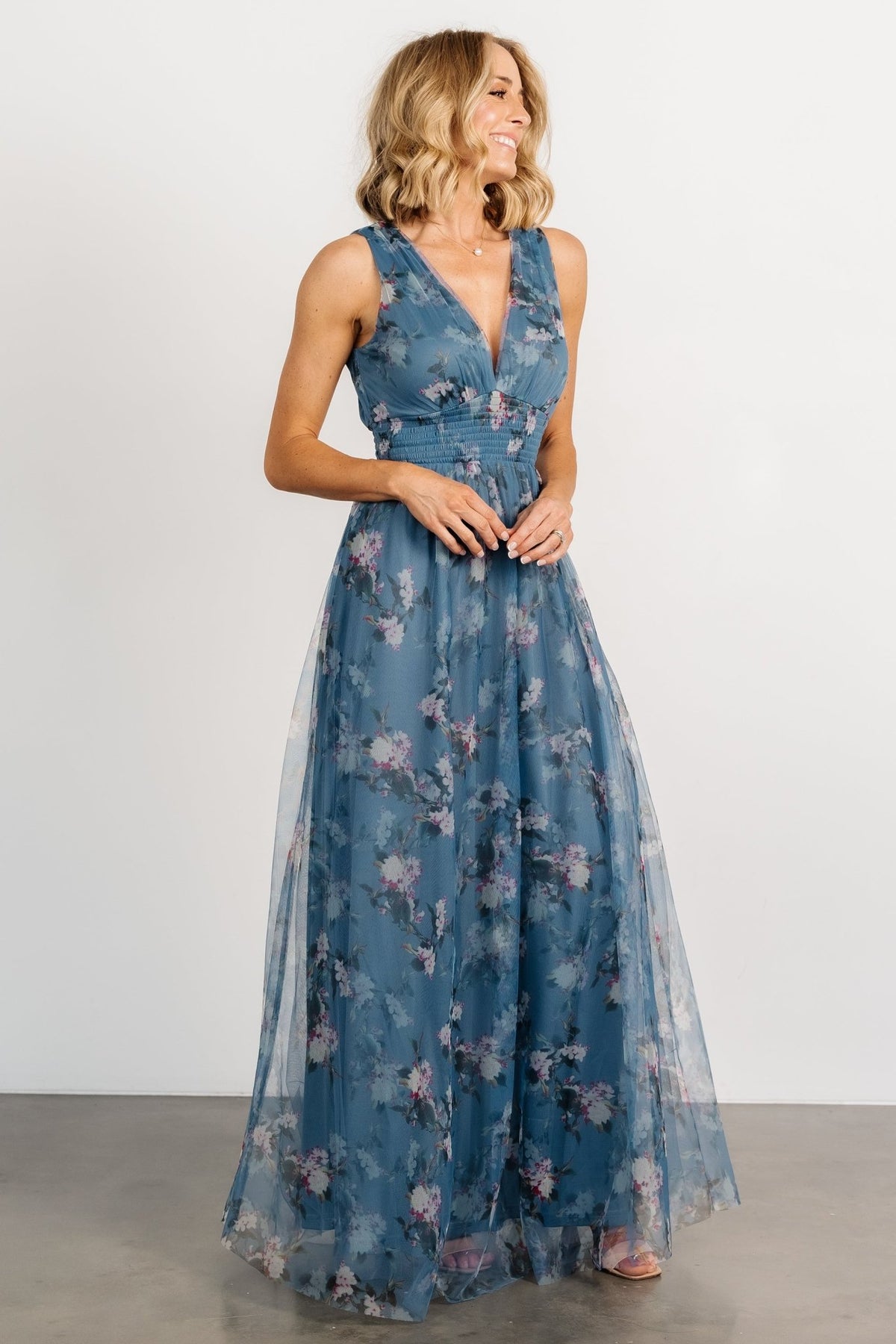 Back and hem detail of Kamila Tulle Maxi Dress in Blue Multi Floral, illustrating length, layered tulle tiers, and clean finish at the skirt.