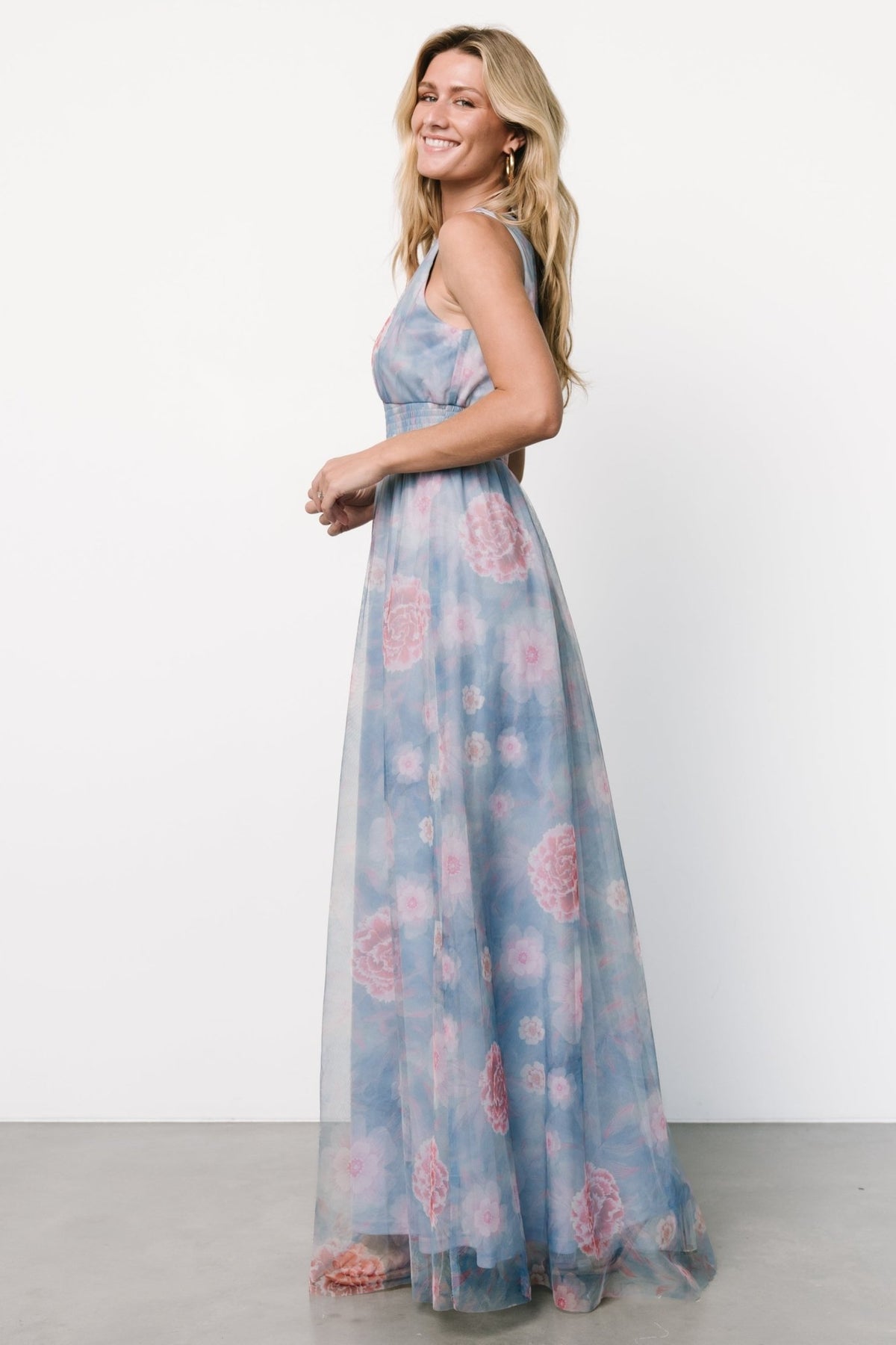 Full-length view of light blue tulle maxi with pink florals, flowing skirt silhouette and gentle movement on model.