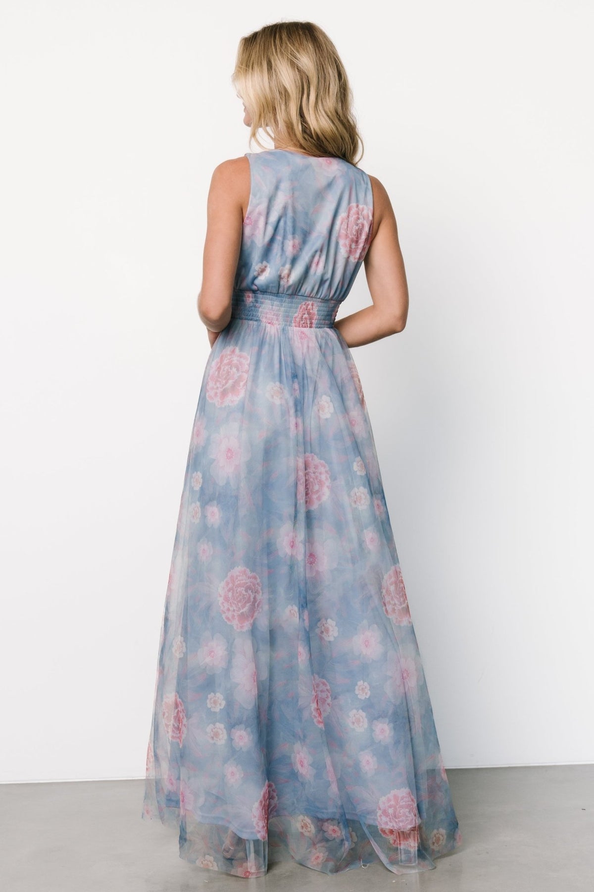 Back and side view of light blue tulle maxi dress showing smocked waist, full lining, and tank-style straps.