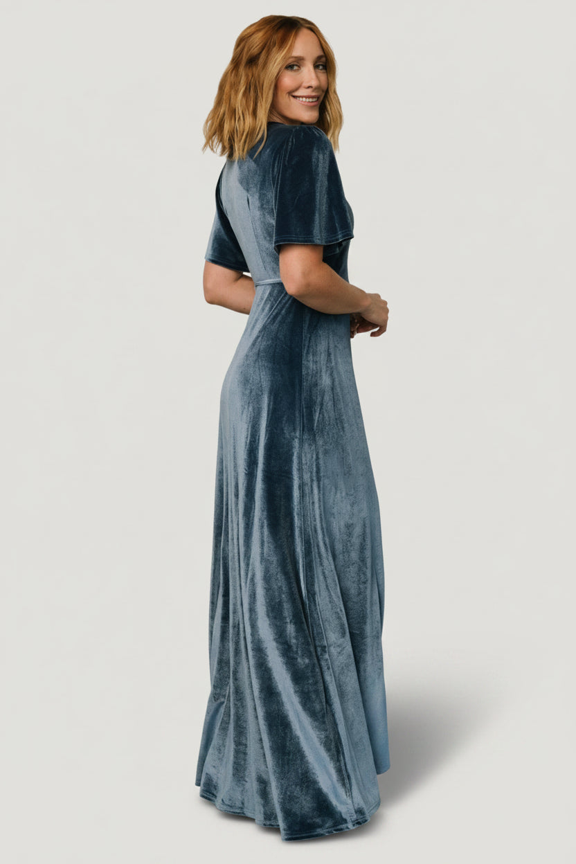 Back and hem detail of soft blue velvet maxi wrap dress emphasizing tulip skirt overlap and full lining.