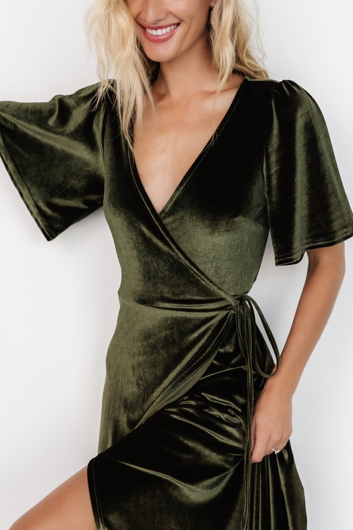 Close-up of the velvet fabric and medium flutter sleeve on the Katelyn Maxi Wrap Dress in dark olive, emphasizing texture and drape.