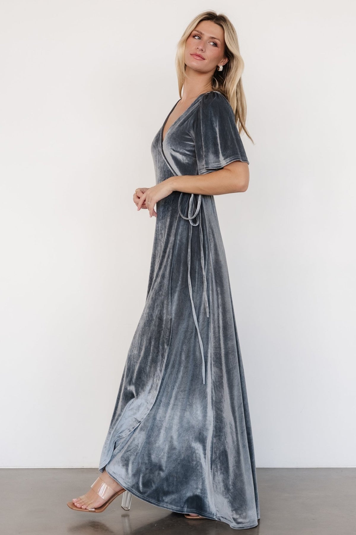 Detail image showing soft velvet texture and slight stretch, close-up of fabric pile and stitching near waist tie and side loop used to secure wrap ties.