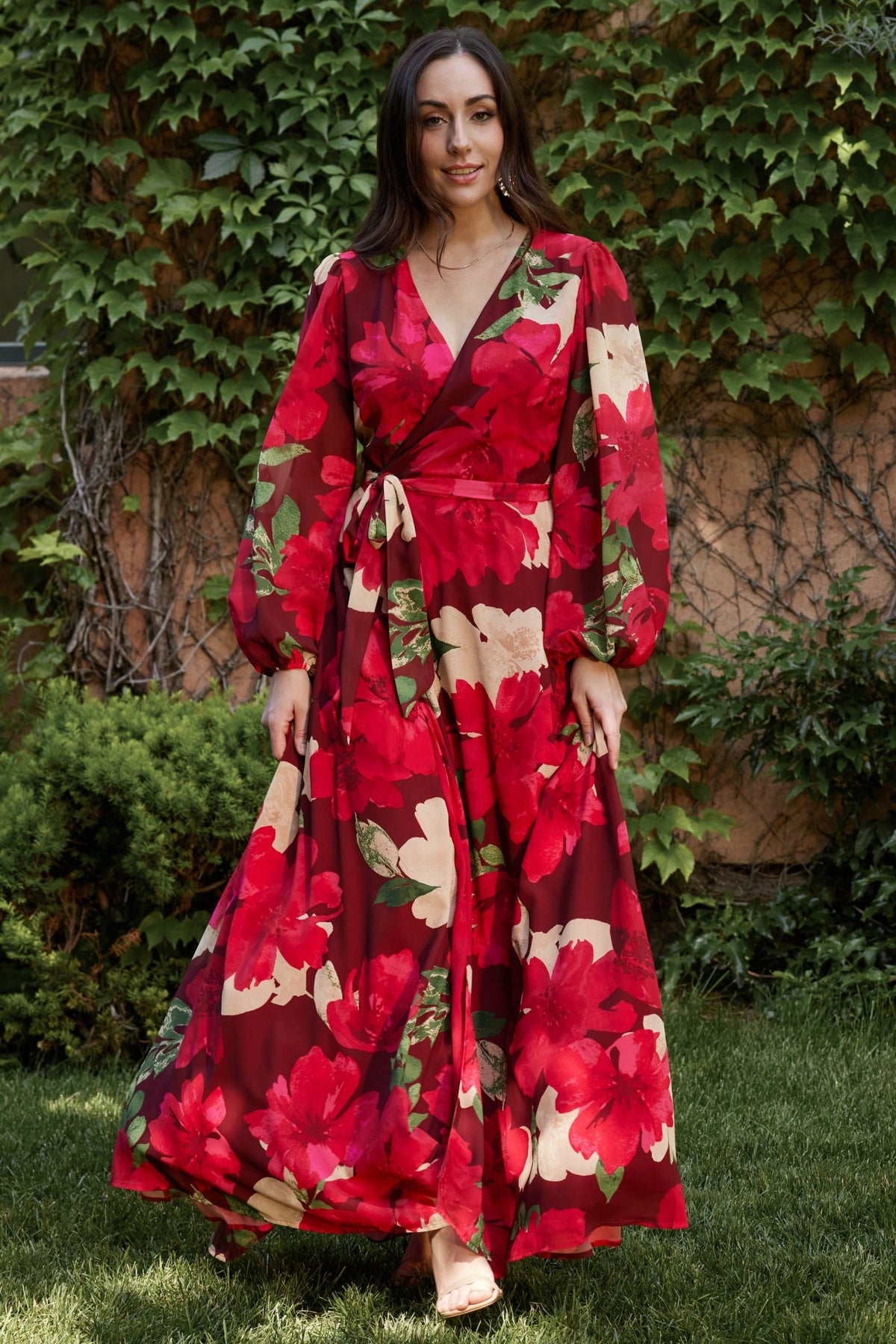 Side profile of Katinka Wrap Maxi Dress in burgundy multi floral showing long bishop sleeve with elastic cuff and gentle skirt drape.