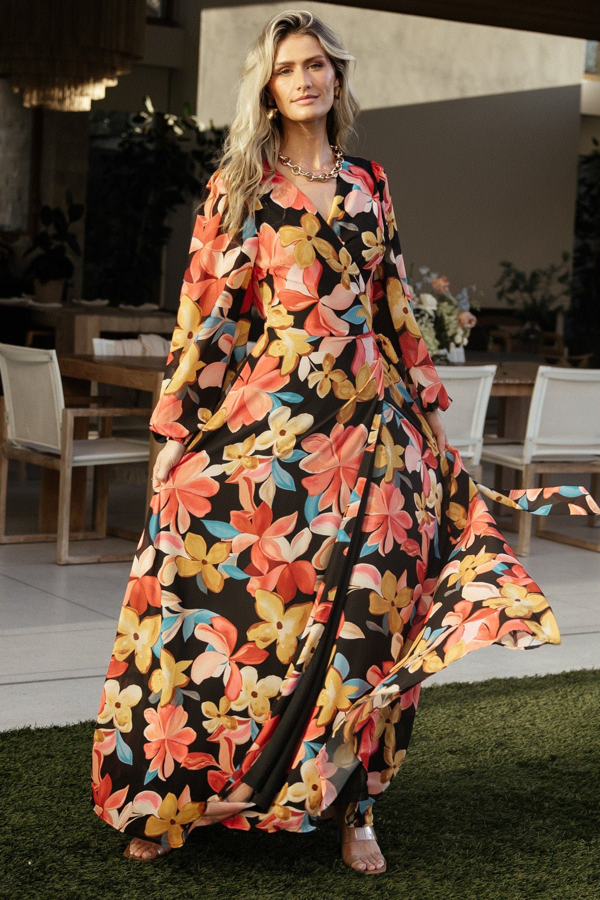 Side profile of Katinka Wrap Maxi Dress showing bishop sleeves with elastic cuffs and the dress's fluid silhouette.
