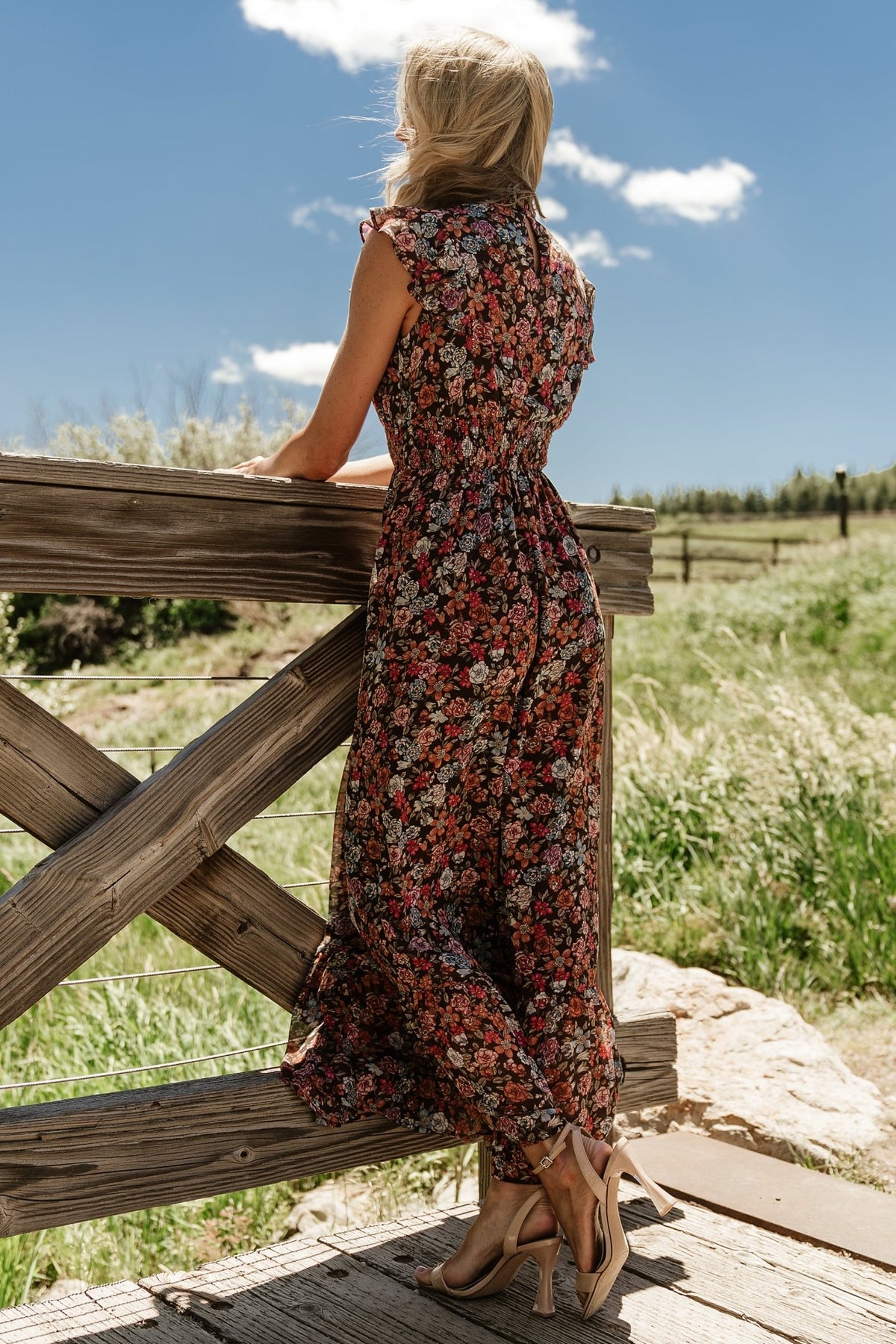 Side view of the dress on model, showing flutter sleeves, gentle drape of chiffon, and how the smocked waist shapes the bodice.
