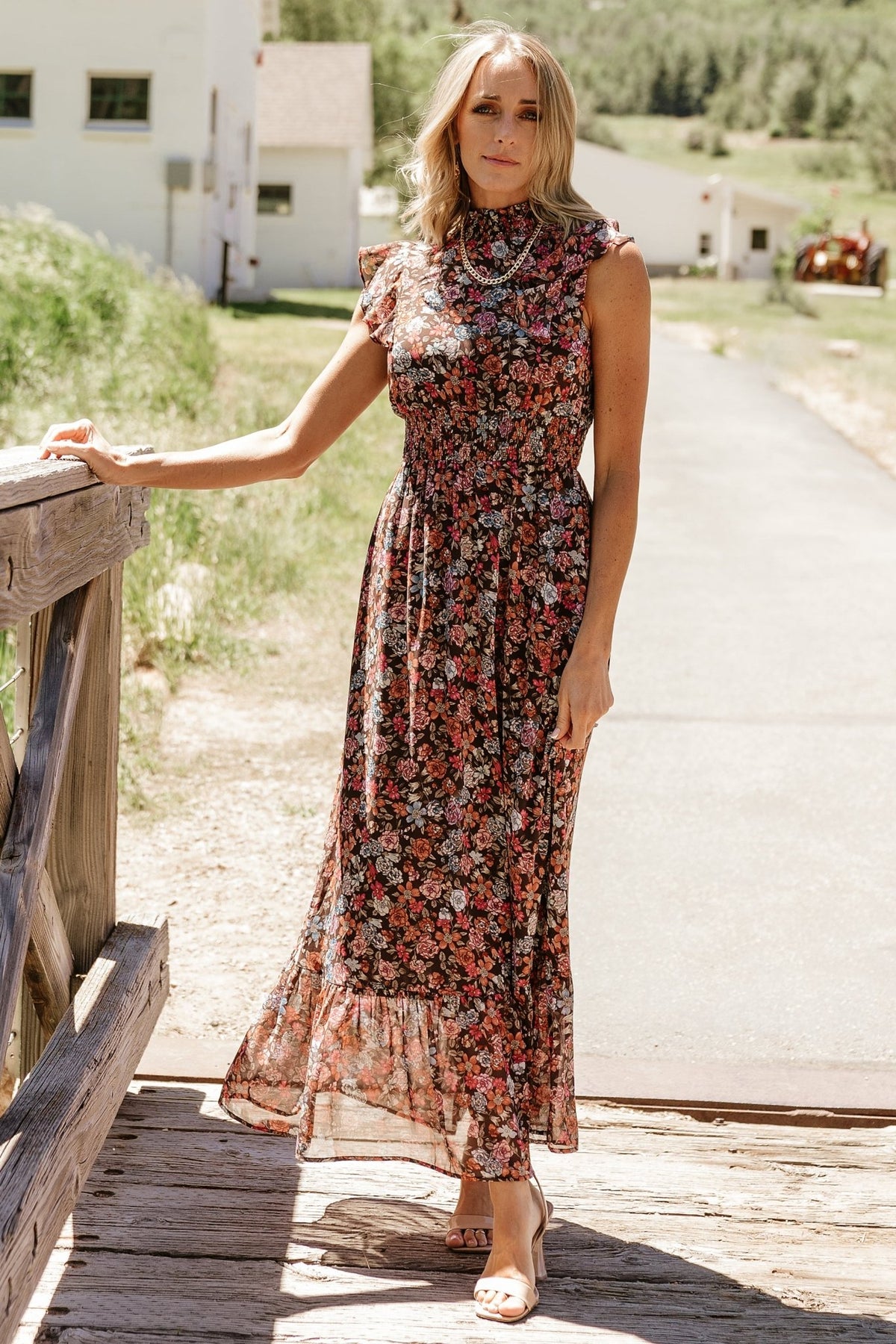 Model wearing the Kearny Ruffle Maxi Dress in a styled look, paired with minimal accessories to showcase silhouette and movement.