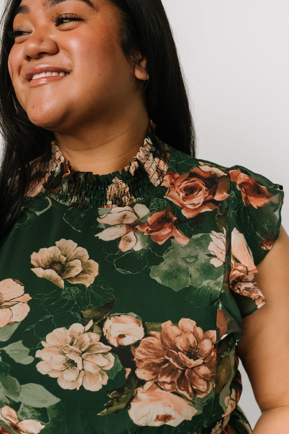 Model wearing the floral chiffon maxi dress styled for occasion wear; short flutter sleeves and layered ruffle skirt visible.