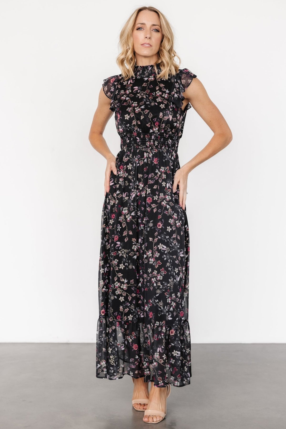 Kearny Ruffle Maxi Dress in Midnight + Gold Multi with gold florals, smocked high neckline, flutter sleeves, and ruffle hem.