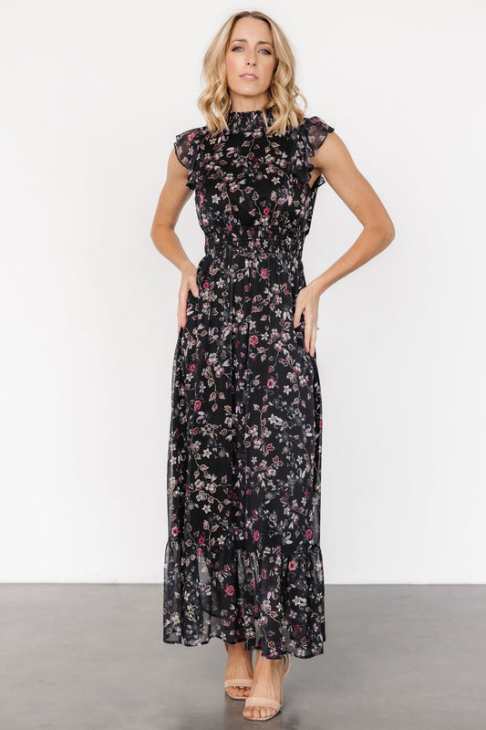 Kearny Ruffle Maxi Dress in Midnight + Gold Multi with gold florals, smocked high neckline, flutter sleeves, and ruffle hem.