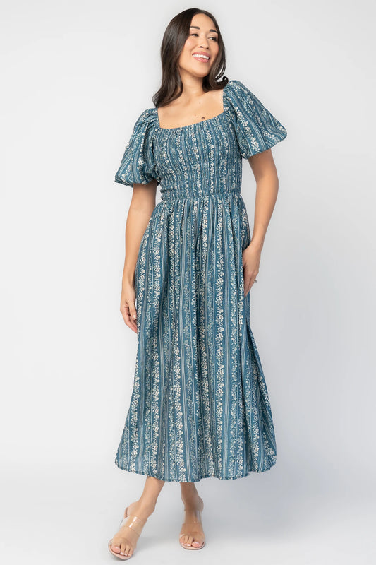 Keira Midi Dress in Blue Print with square neckline, smocked bodice, short puff sleeves, and midi skirt.