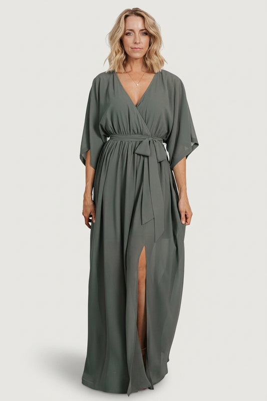 Front view of dark sage Kia kimono maxi dress on model, showing surplice neckline, elastic waist and flowing skirt (front).