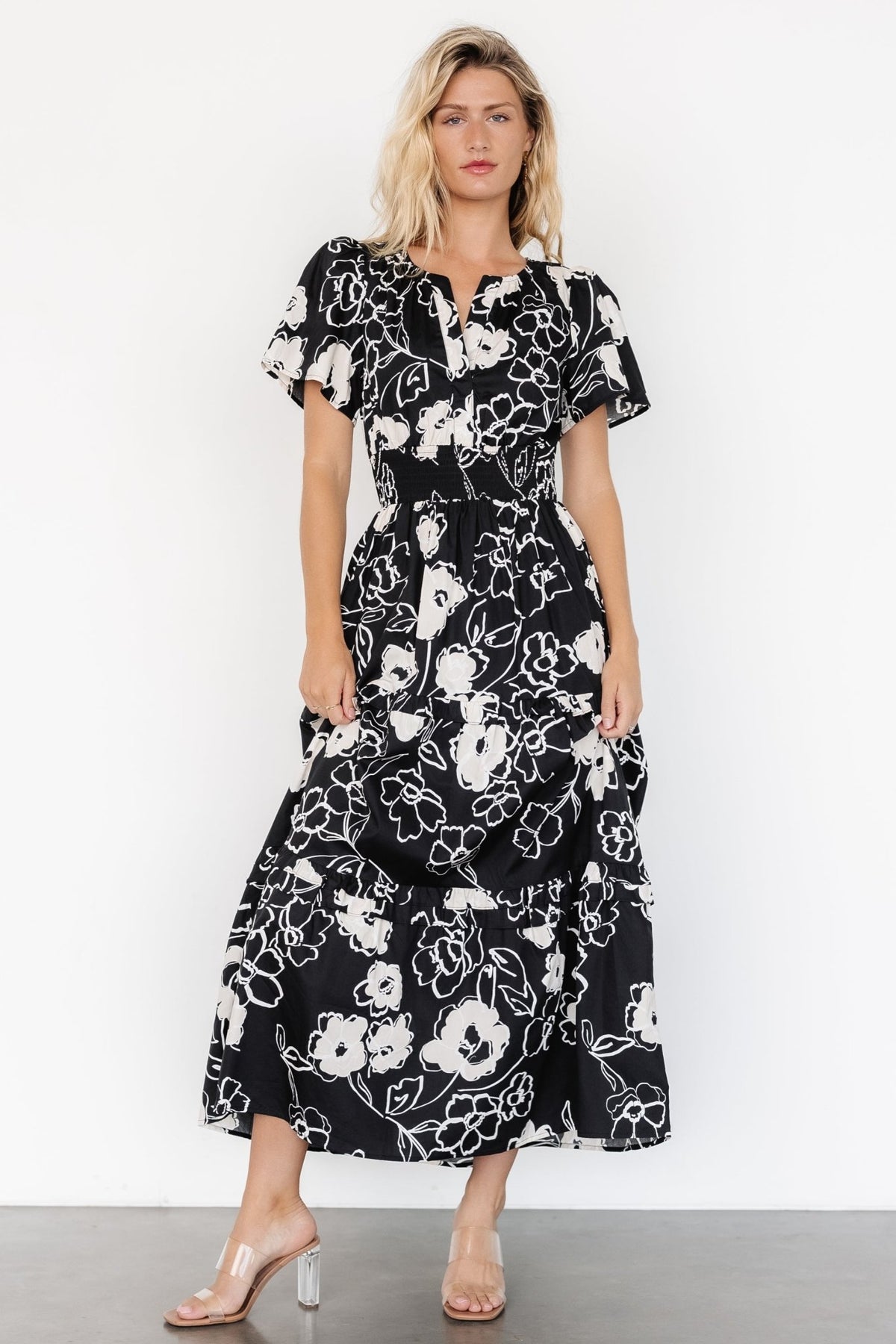 Fabric close-up of the Kiana Poplin Maxi Dress showing 100% cotton weave and black and cream print texture.