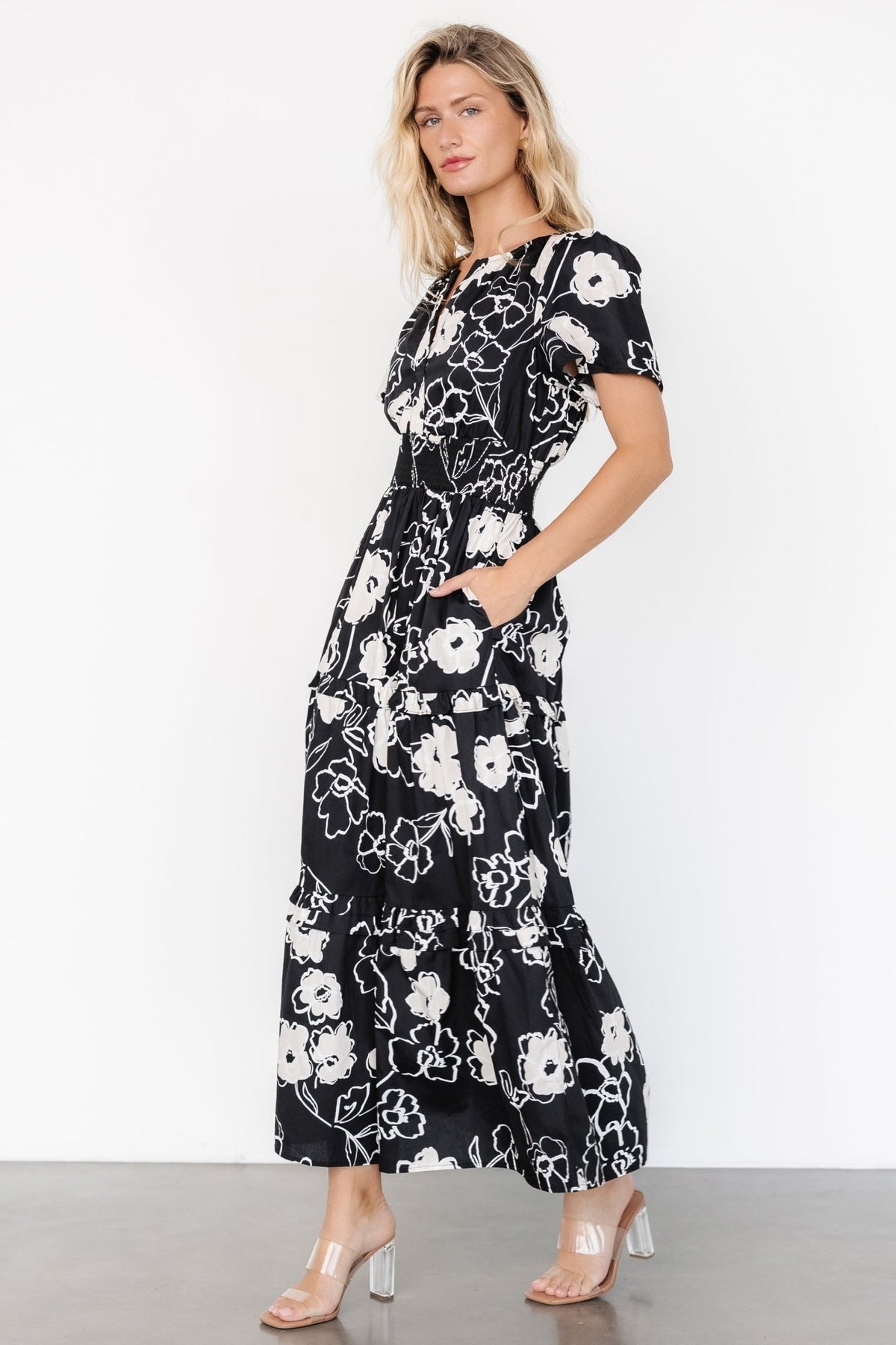 Back view of the Kiana Poplin Maxi Dress in black and cream print, highlighting the tiered skirt and ankle-length silhouette.